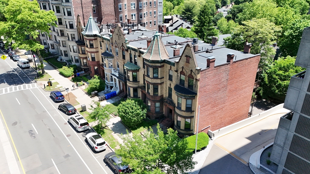 1495 Beacon Street, Unit 3 Brookline, MA 02446 - Photo 24 of 27 a aerial view of a house with a yard and fountain in middle