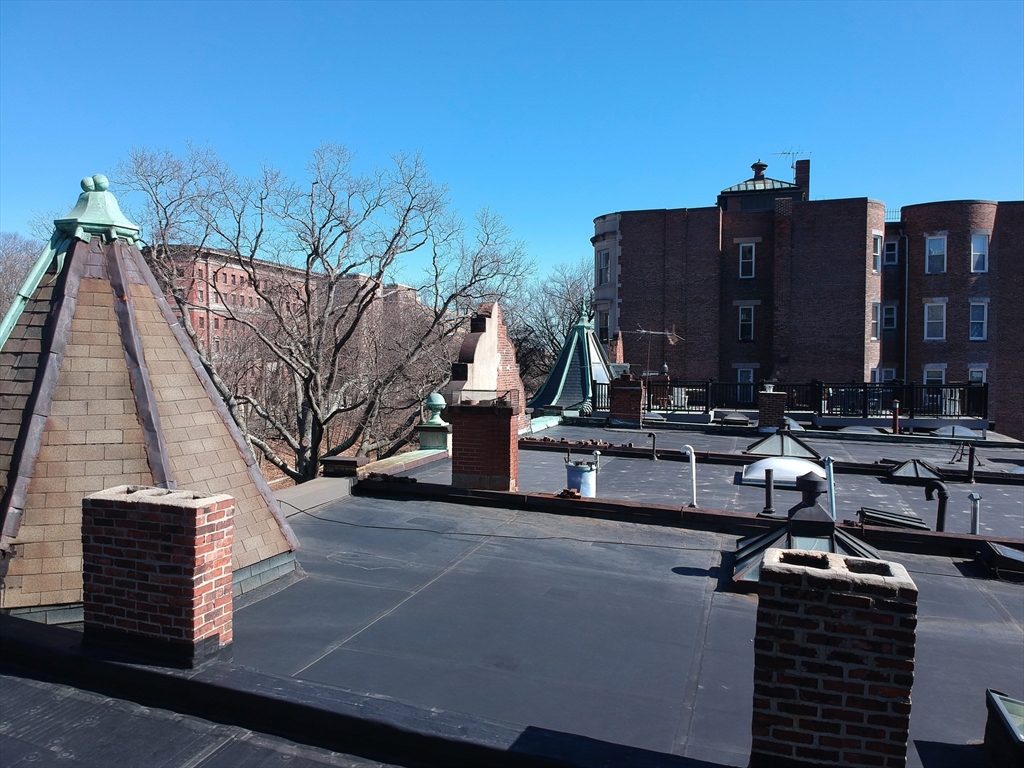 1495 Beacon Street, Unit 3 Brookline, MA 02446 - Photo 27 of 27 a view of a buildings with a bench
