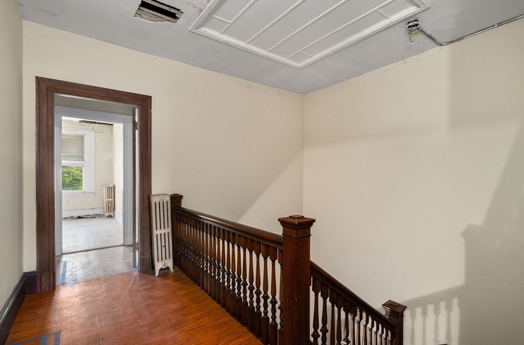 1495 Beacon Street, Unit 3 Brookline, MA 02446 - Photo 5 of 27 a view of a hallway with a chandelier
