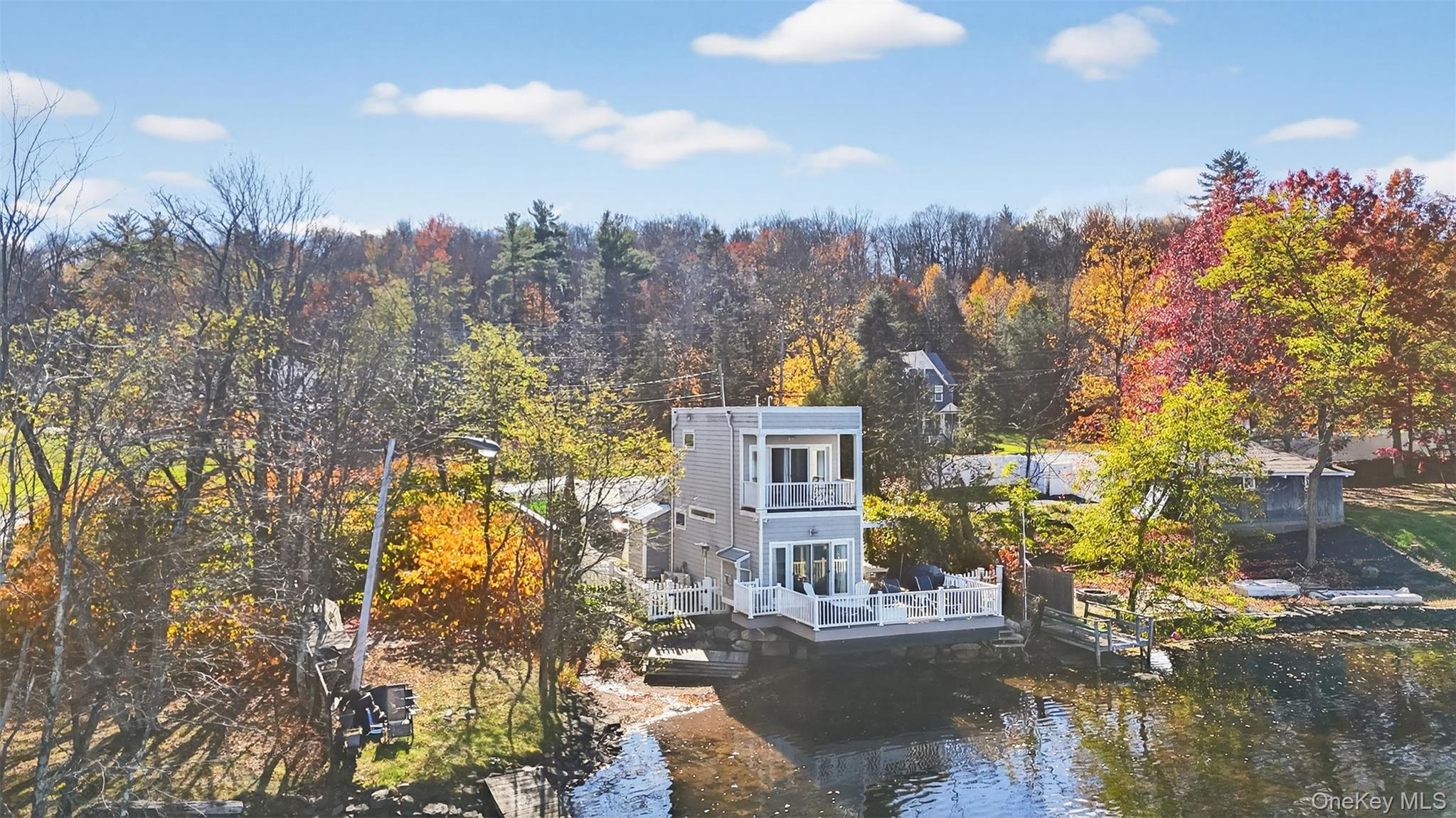 a view of a house with a yard and sitting area
