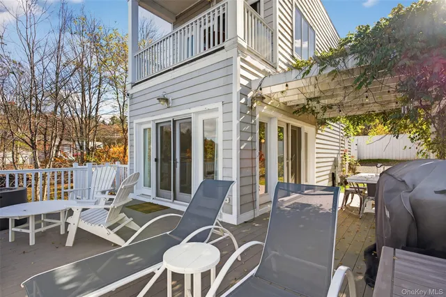 a view of a patio with couches table and chairs and potted plants