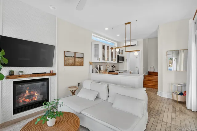 a living room with furniture a flat screen tv and a fireplace