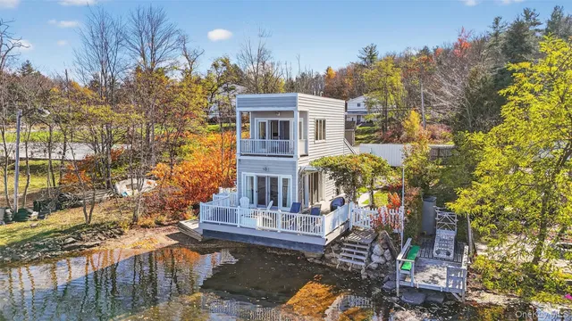 a front view of a house with a yard and fountain