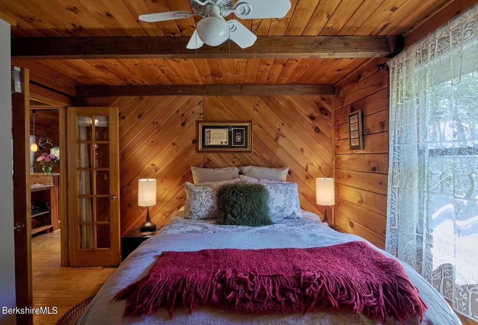 2232 Jacobs Ladder Road Becket, MA 01223 - Photo 11 of 44 a bedroom with a bed and wooden floor