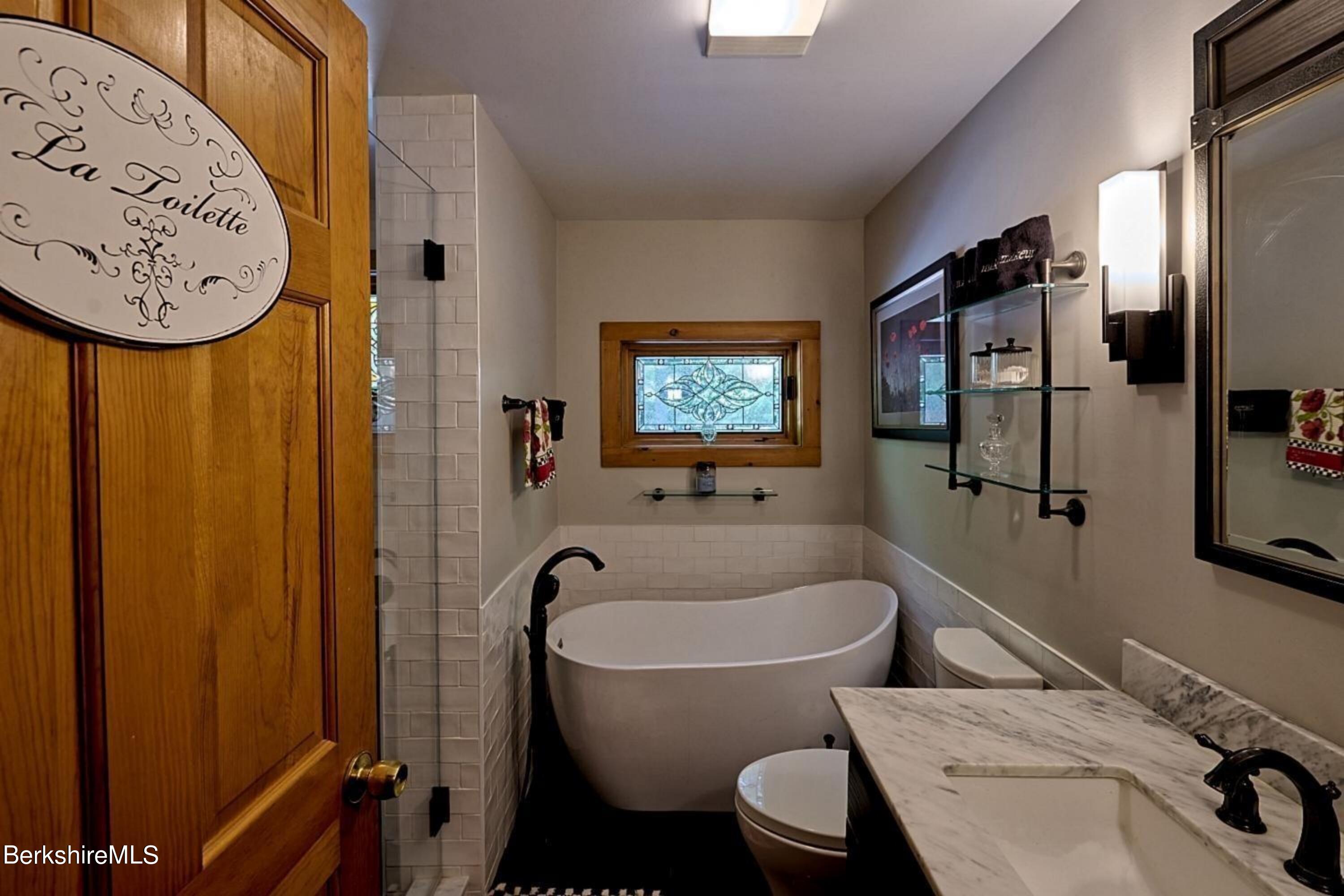 2232 Jacobs Ladder Road Becket, MA 01223 - Photo 12 of 44 a bathroom with a sink and a bathtub