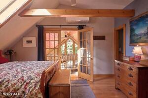 2232 Jacobs Ladder Road Becket, MA 01223 - Photo 16 of 44 a large bedroom with a bed and a balcony view