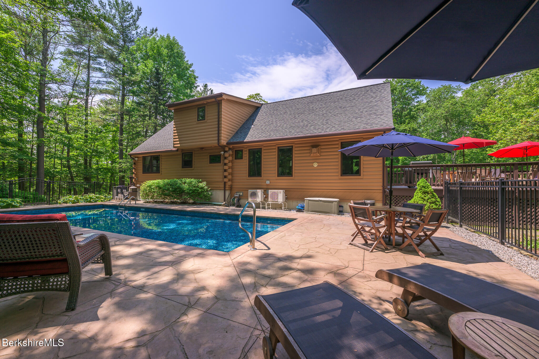 2232 Jacobs Ladder Road Becket, MA 01223 - Photo 32 of 44 a view of a patio with table and chairs under an umbrella