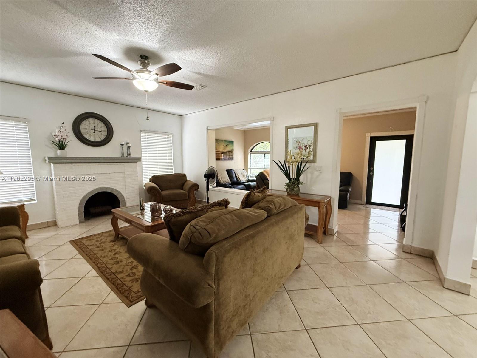 1835 Southwest 10th Street Miami, FL 33135 - Photo 12 of 50 a living room with furniture a clock and a fireplace