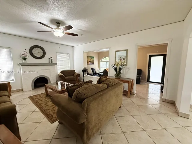 a living room with furniture a clock and a fireplace