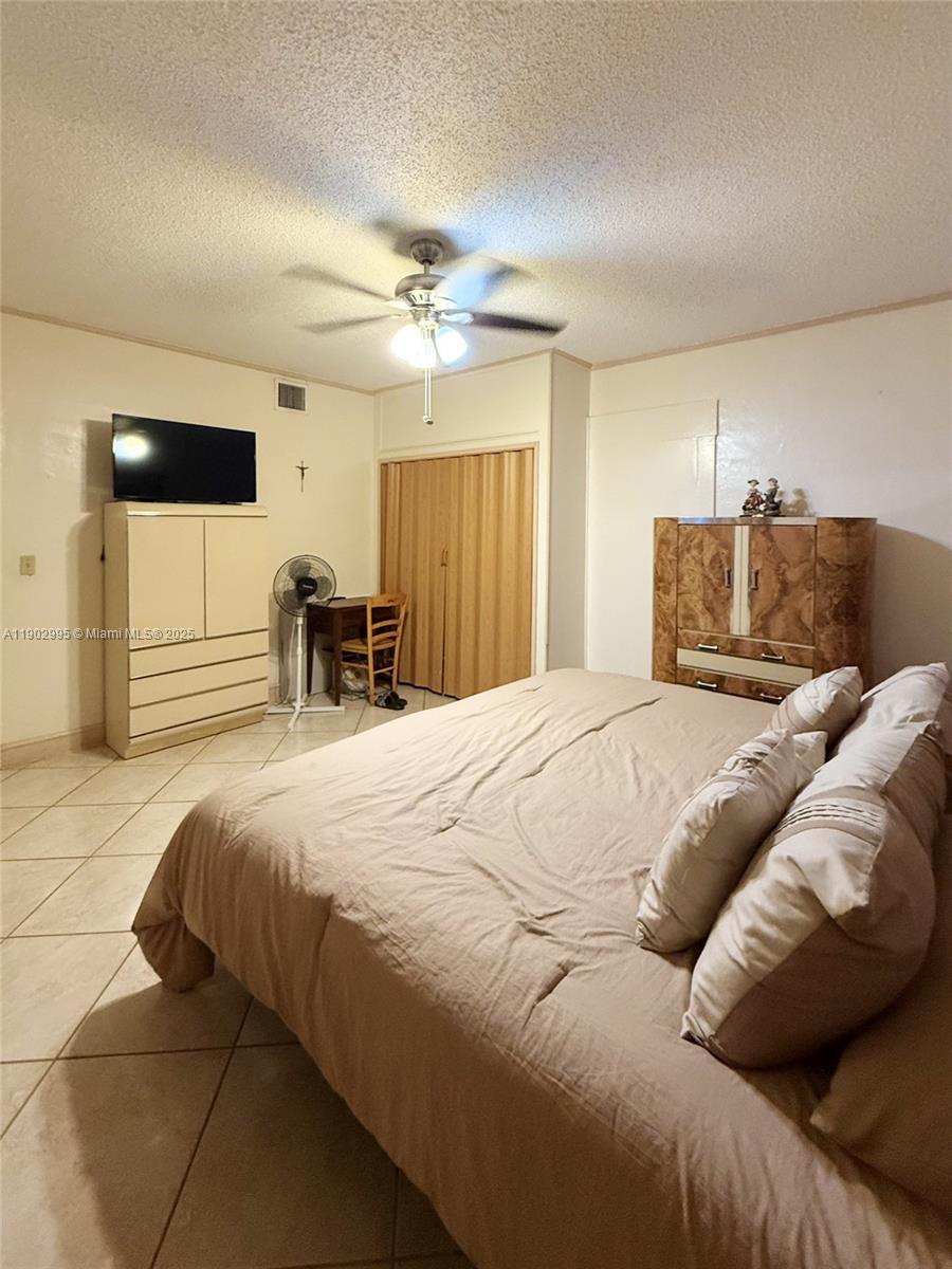 1835 Southwest 10th Street Miami, FL 33135 - Photo 14 of 50 a bedroom with a large bed and a chair