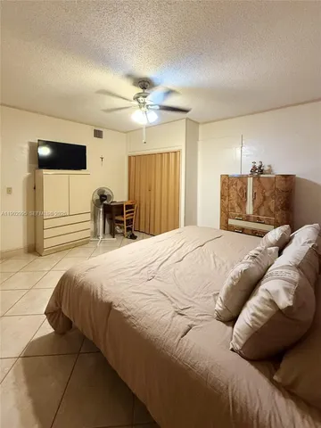 a bedroom with a large bed and a chair