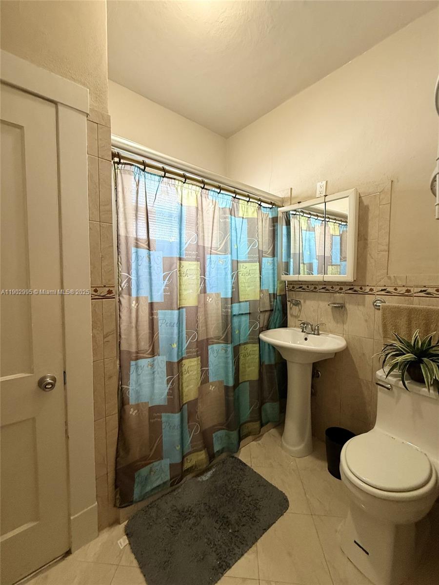 1835 Southwest 10th Street Miami, FL 33135 - Photo 19 of 50 a bathroom with a sink toilet and shower
