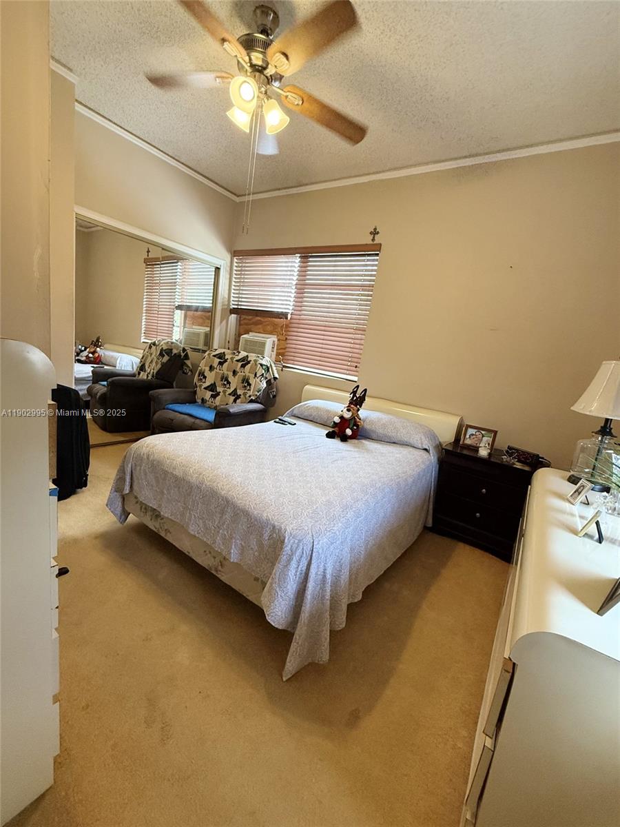 1835 Southwest 10th Street Miami, FL 33135 - Photo 20 of 50 a bedroom with a bed and a chandelier