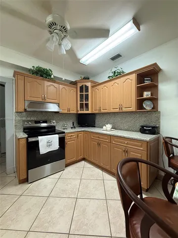 a kitchen with granite countertop a stove a sink and a granite counter tops