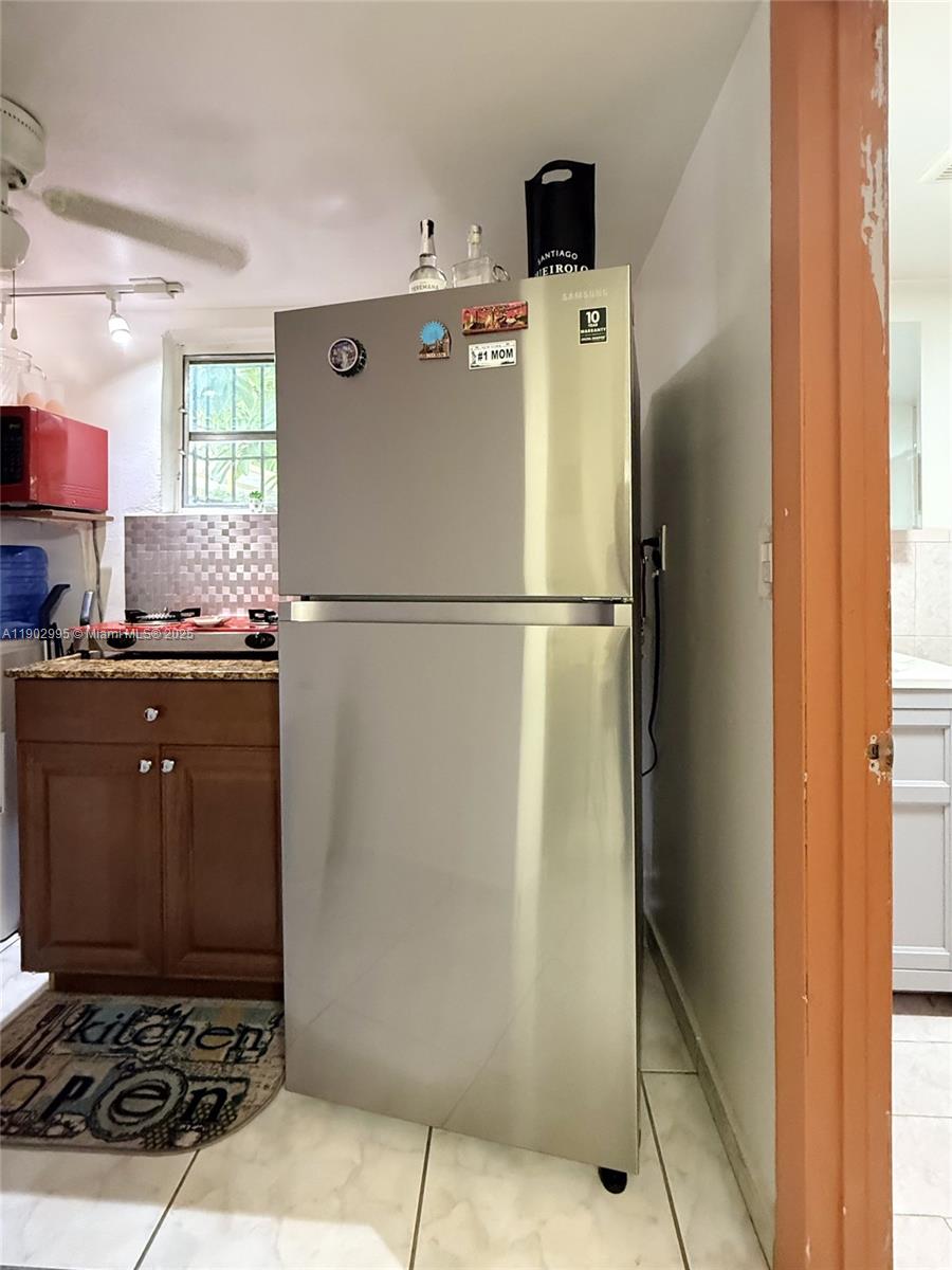 1835 Southwest 10th Street Miami, FL 33135 - Photo 41 of 50 a white refrigerator freezer sitting in a kitchen