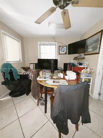 a kitchen with a refrigerator a stove a sink and white cabinets