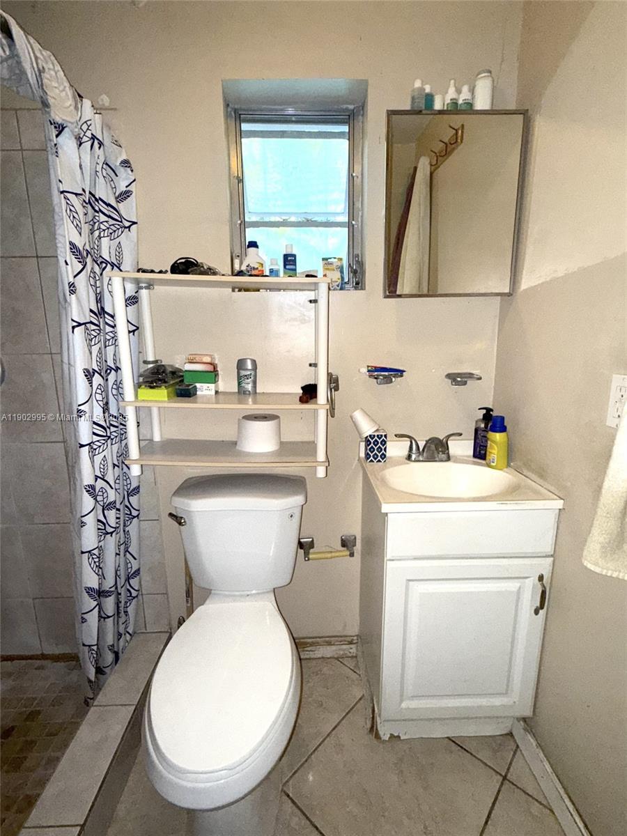1835 Southwest 10th Street Miami, FL 33135 - Photo 47 of 50 a bathroom with a toilet sink and mirror