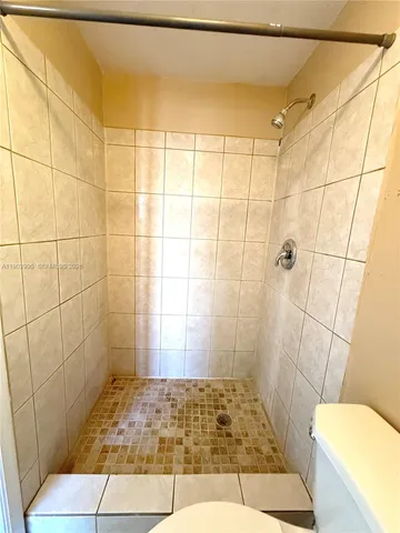 a bathroom with a toilet a sink and a mirror