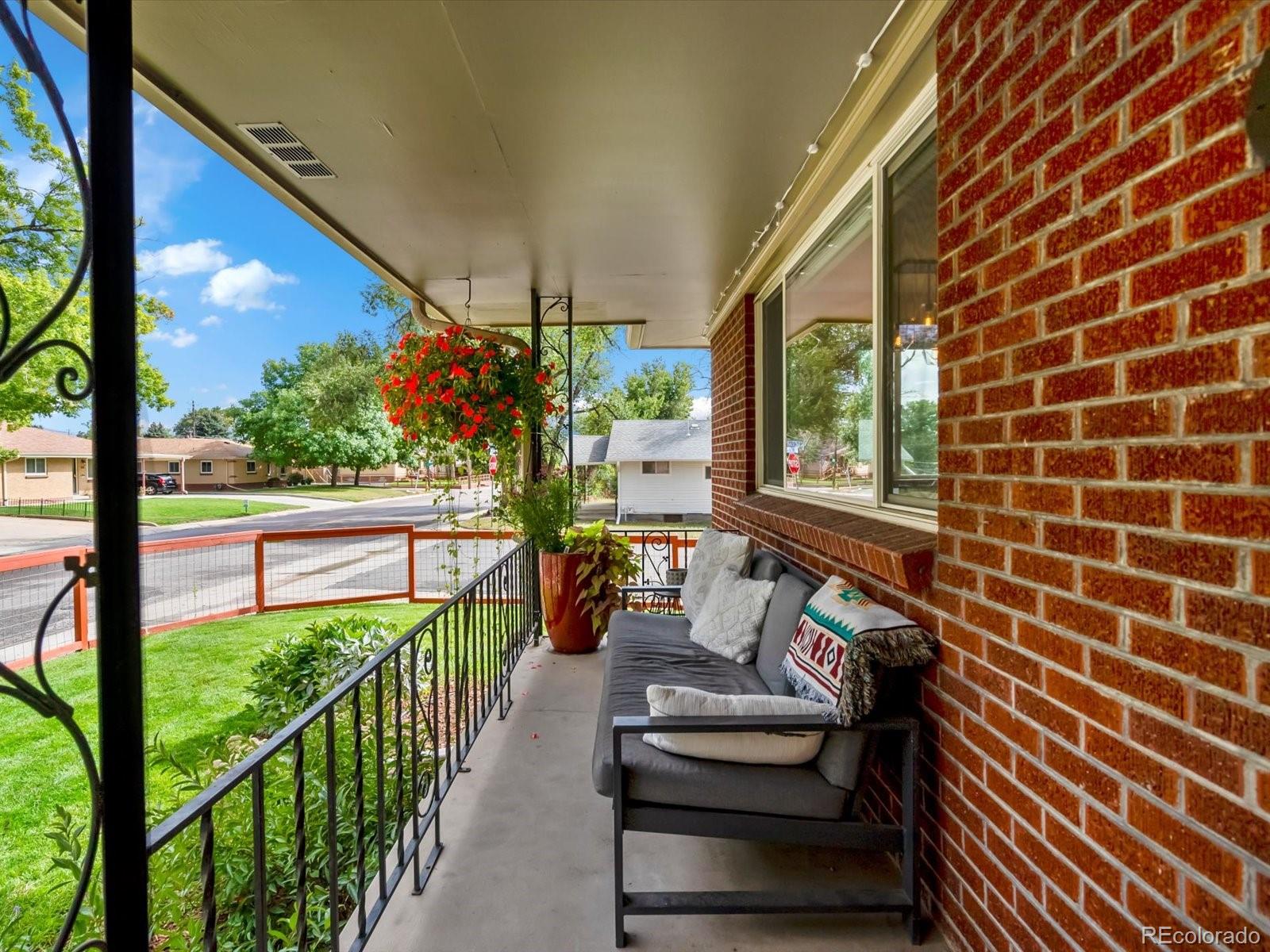 4963 North Harlan Street Wheat Ridge, CO 80033 - Photo 4 of 42 a view of a porch with wooden floor and outdoor seating