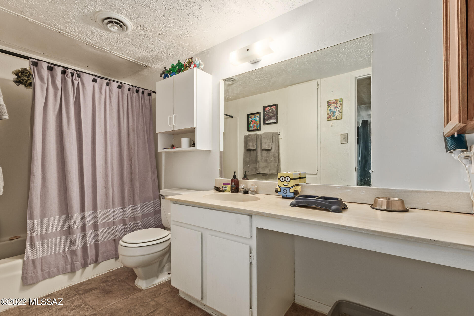 1620 North Wilmot Road, Unit D273 Tucson, AZ 85712 - Photo 10 of 15 a bathroom with a double vanity sink toilet and shower