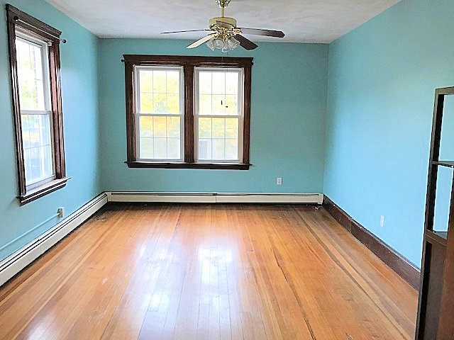 45 Water Street, Unit 2 Quincy, MA 02169 - Photo 12 of 14 an empty room with wooden floor and windows