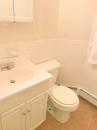 a white toilet sitting next to a bathroom sink