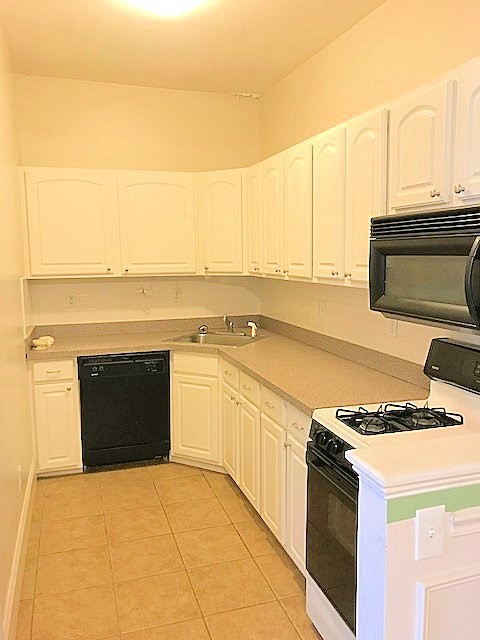 45 Water Street, Unit 2 Quincy, MA 02169 - Photo 10 of 14 a kitchen with stainless steel appliances granite countertop a stove and a white cabinets
