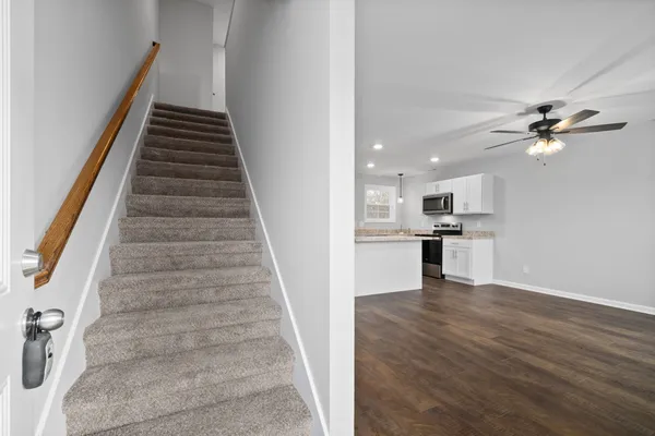 a view of kitchen and hall with wooden floor