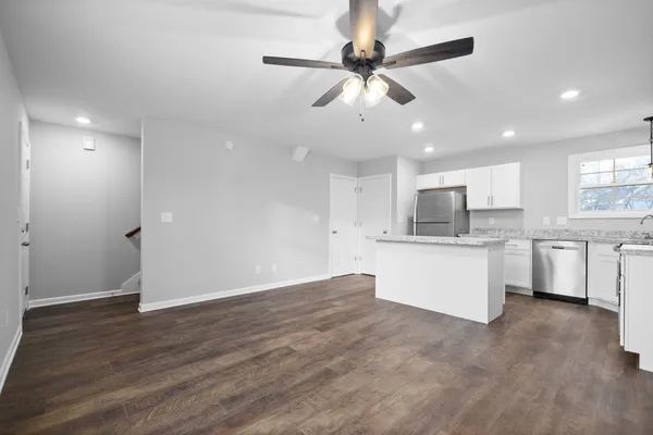a view of kitchen with stainless steel appliances refrigerator stove microwave and cabinets