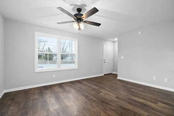 wooden floor in an empty room with a window