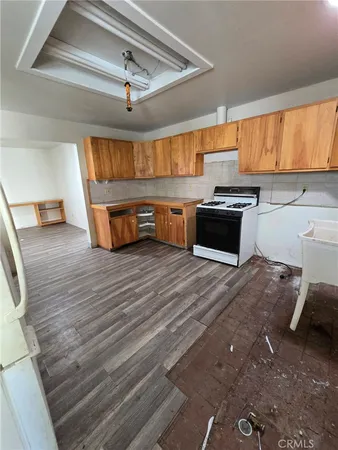 a kitchen with stainless steel appliances wooden cabinets and a stove top oven