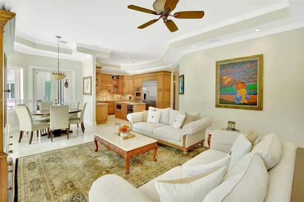 a living room with furniture and a view of kitchen