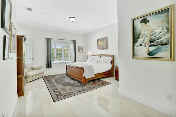 a bedroom with a bed lamp and large window