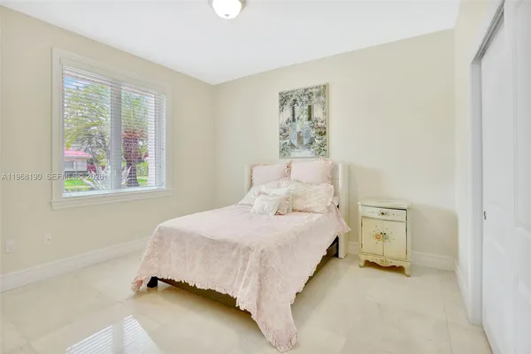a bedroom with a bed and a painting on the wall