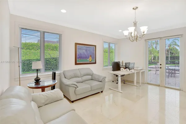 a living room with furniture and a chandelier