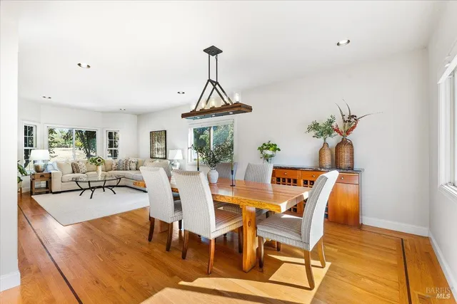a view of a dining room with furniture window and wooden floor