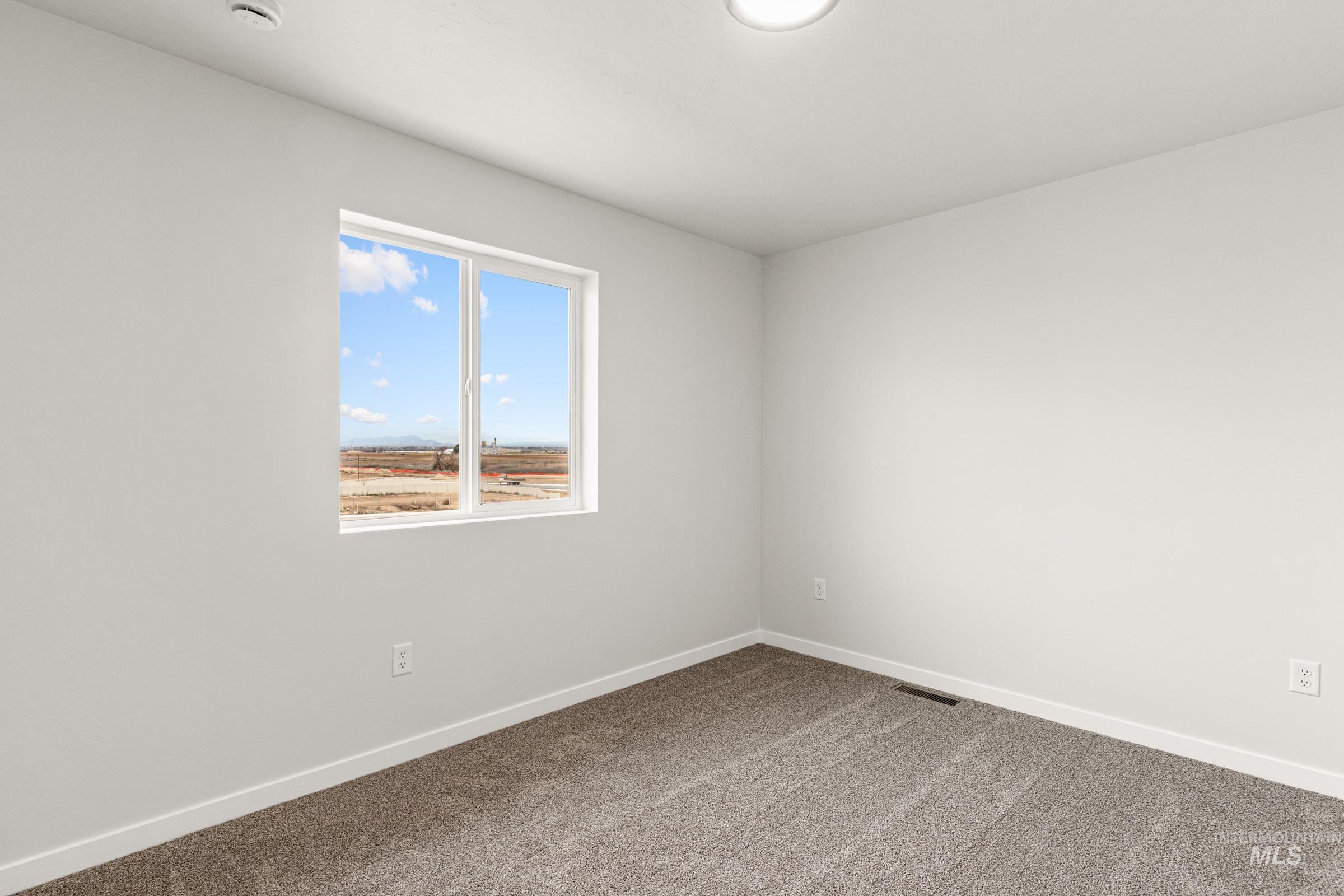 10824 Rutland Street Caldwell, ID 83605 - Photo 11 of 20 Unfurnished room with baseboards and carpet floors