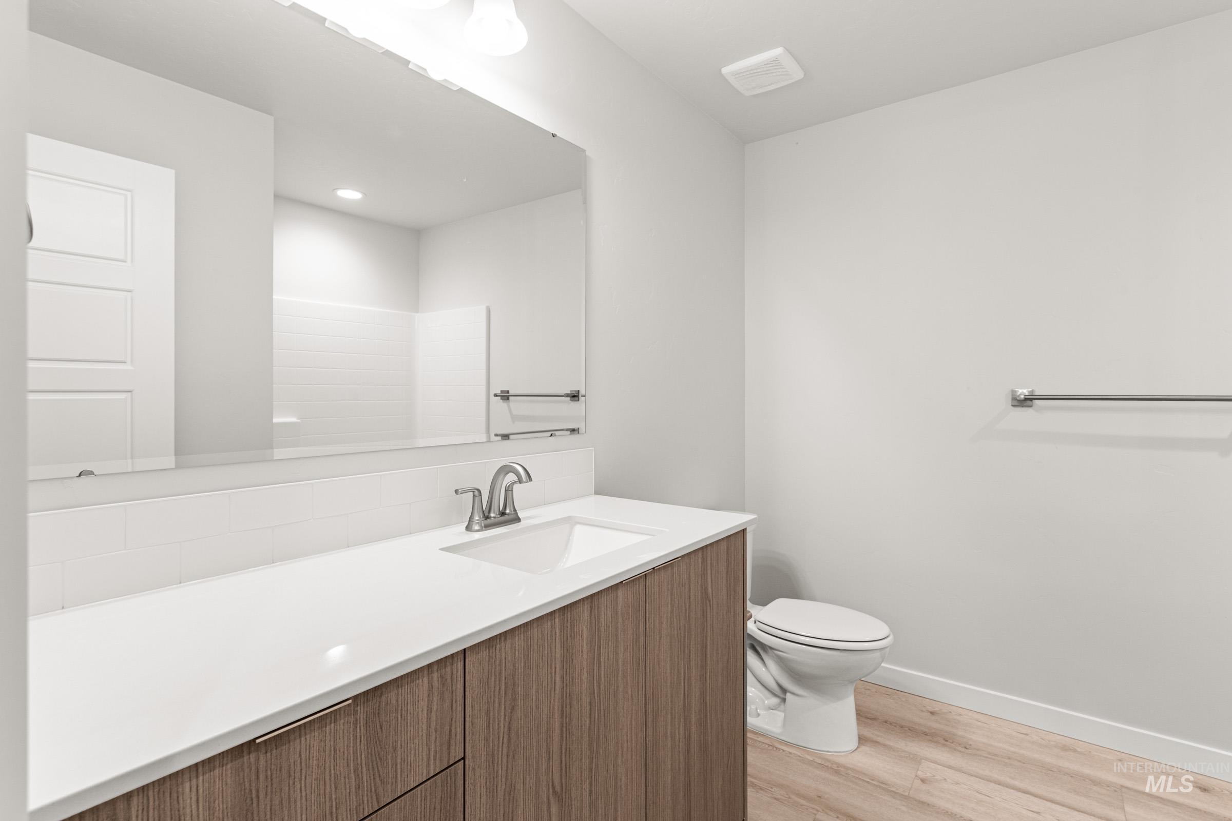 10824 Rutland Street Caldwell, ID 83605 - Photo 12 of 20 Full bathroom with vanity and light wood finished floors