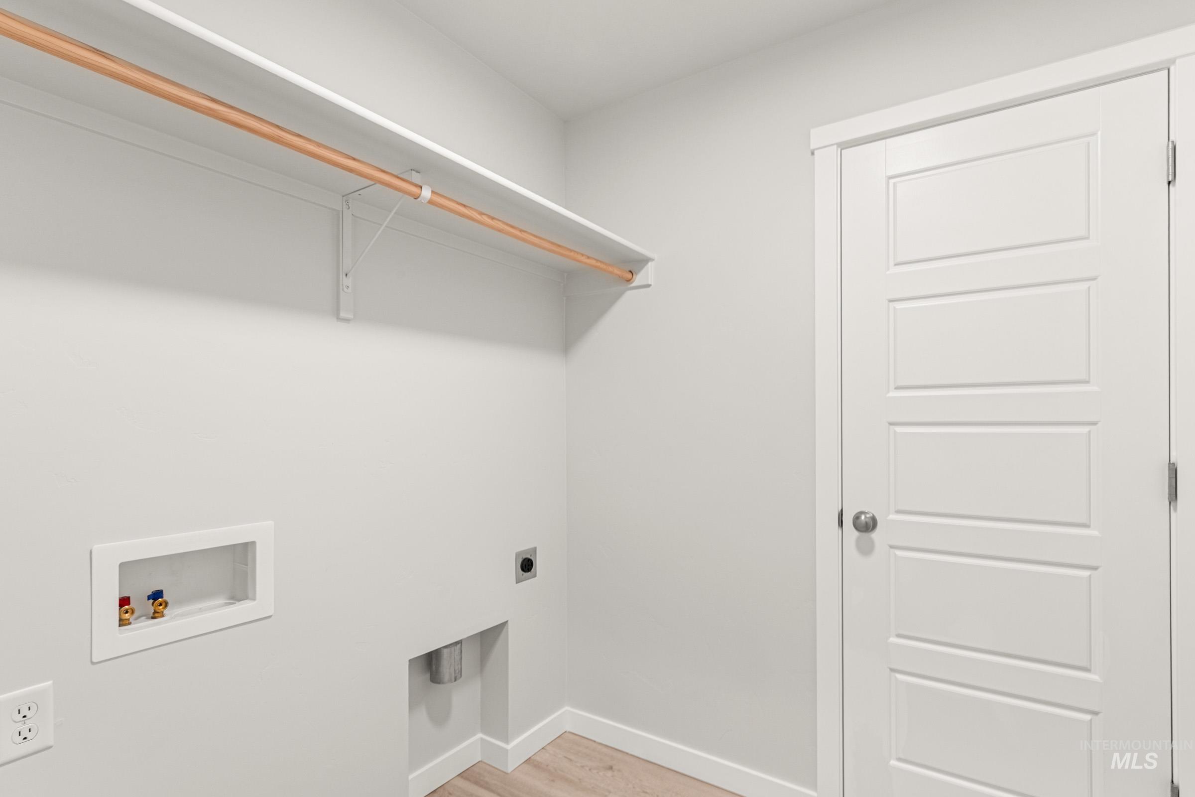 10824 Rutland Street Caldwell, ID 83605 - Photo 13 of 20 Laundry room with hookup for an electric dryer, light wood-style floors, and washer hookup