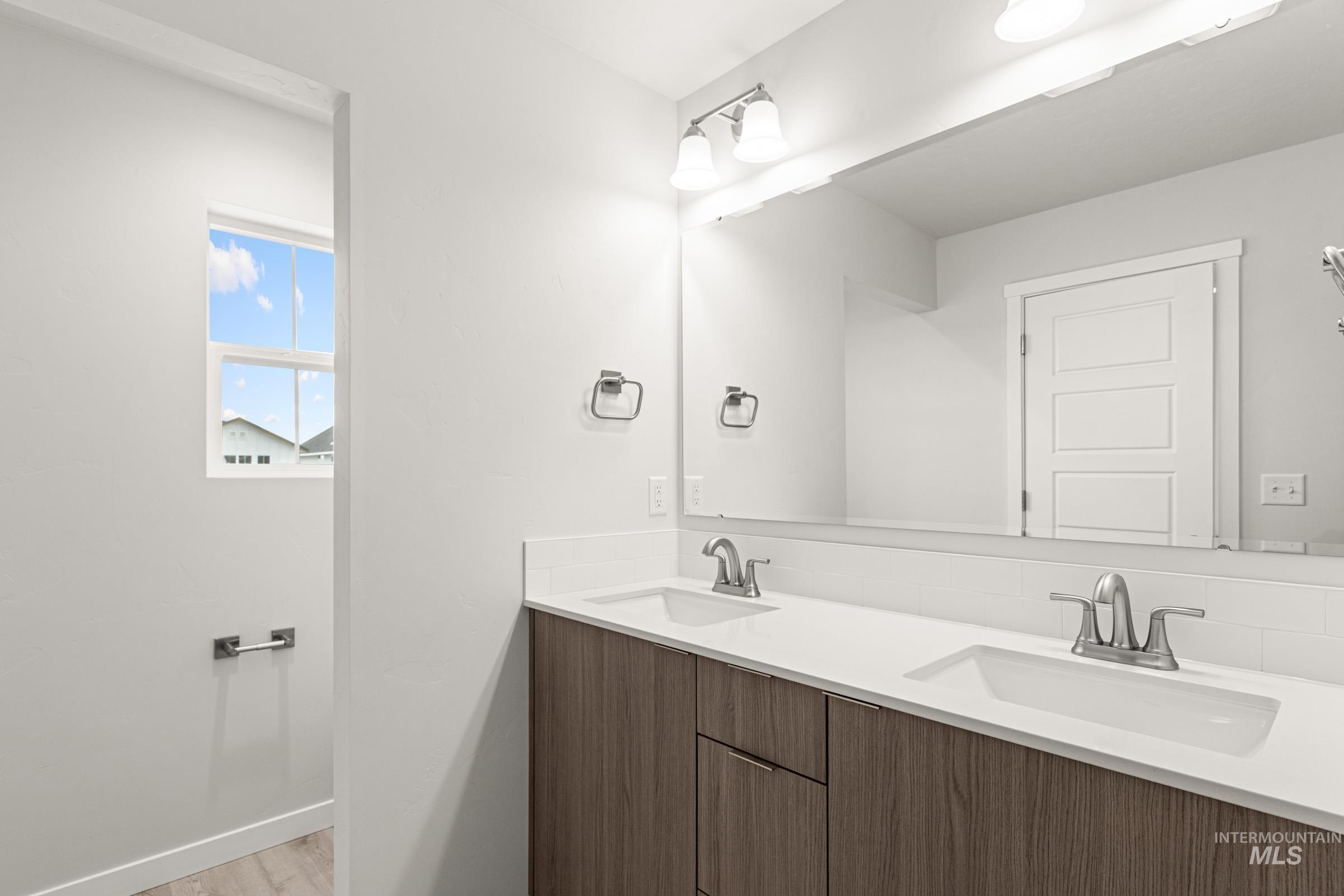10824 Rutland Street Caldwell, ID 83605 - Photo 17 of 20 Full bathroom featuring double vanity and light wood-style floors