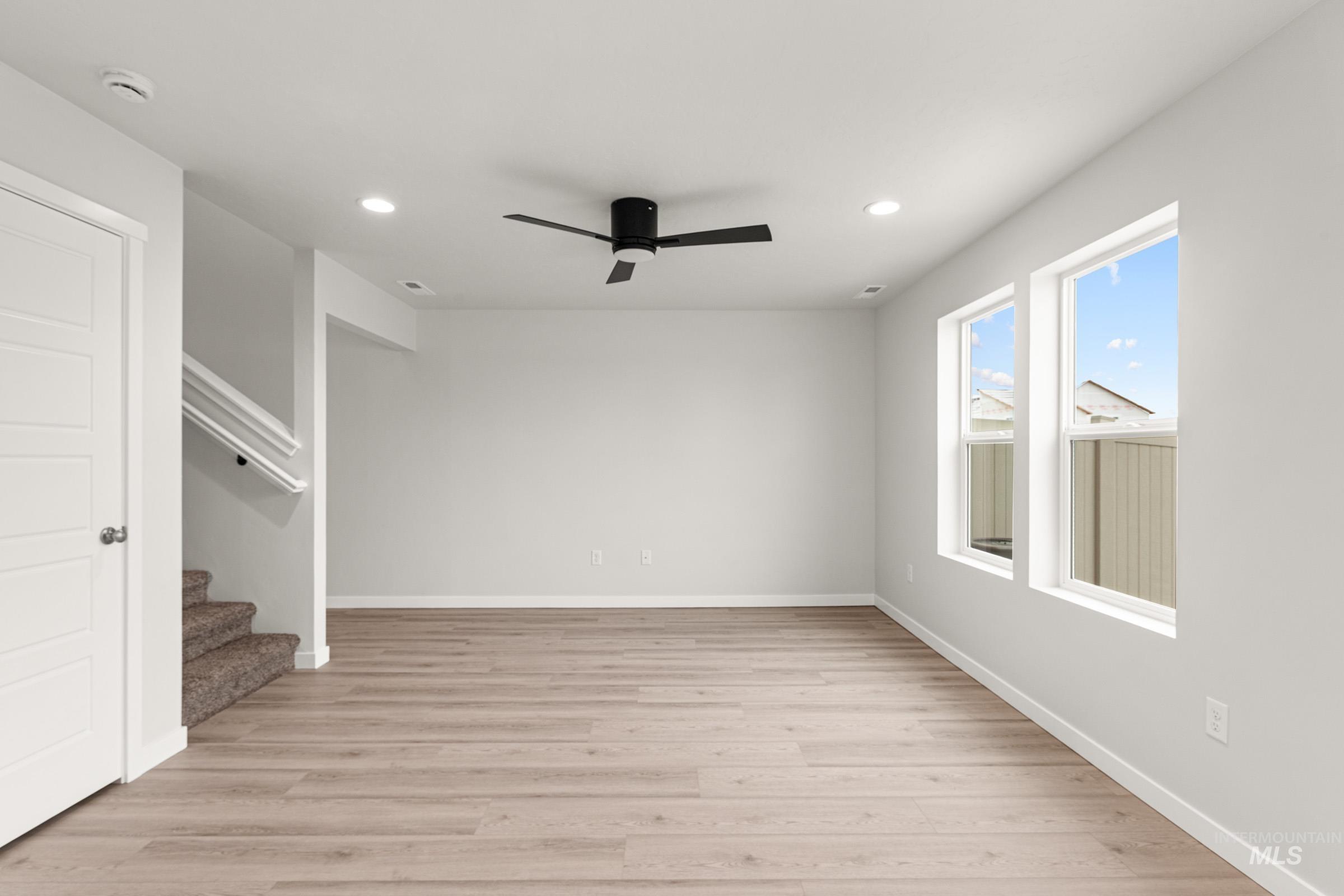 10824 Rutland Street Caldwell, ID 83605 - Photo 8 of 20 Spare room featuring ceiling fan, light wood finished floors, and recessed lighting
