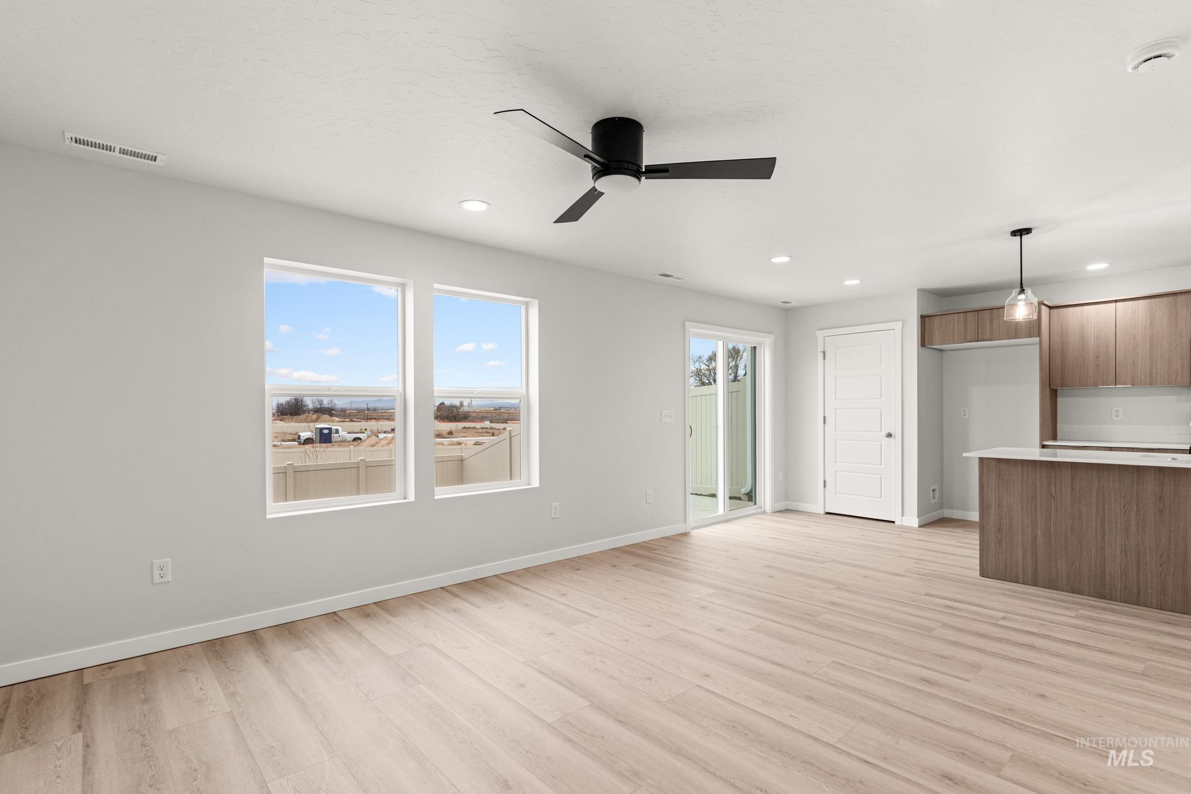 10824 Rutland Street Caldwell, ID 83605 - Photo 9 of 20 Unfurnished living room featuring a ceiling fan, light wood-style flooring, and recessed lighting