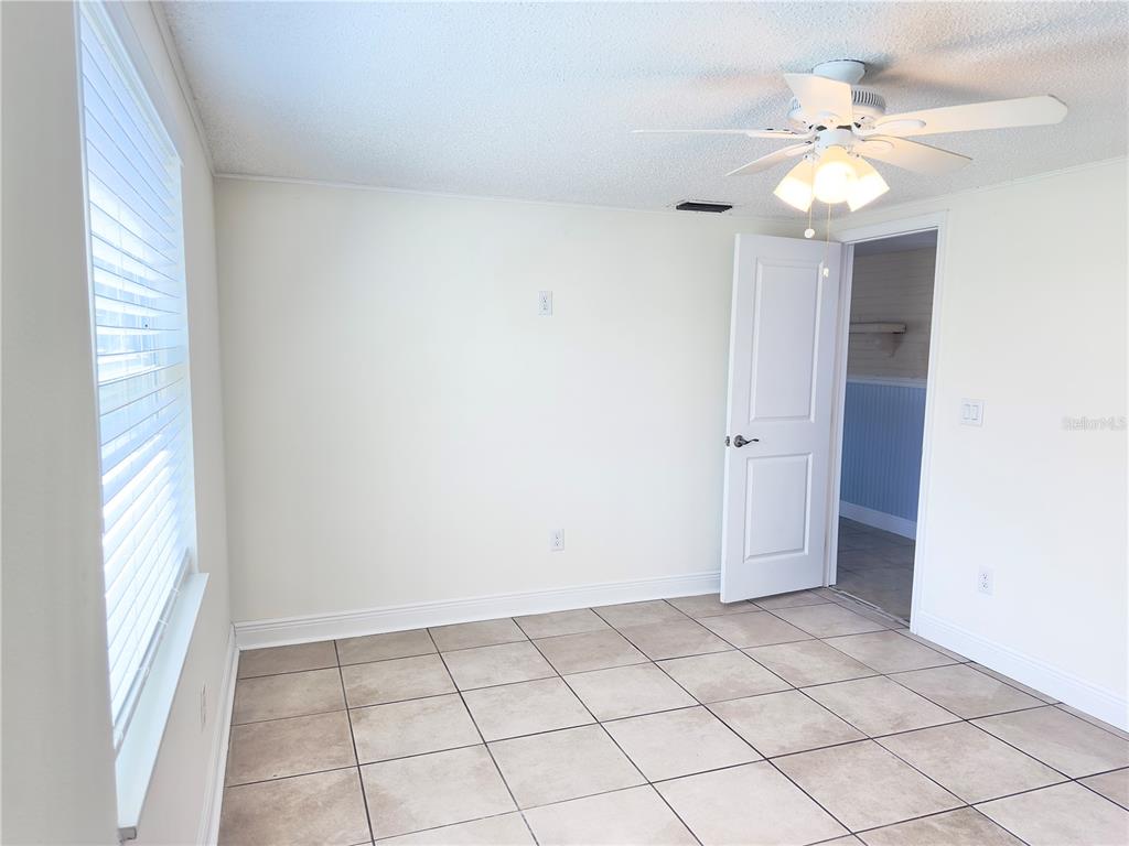 5701 Quist Drive Port Richey, FL 34668 - Photo 12 of 53 wooden floor in an empty room with a window