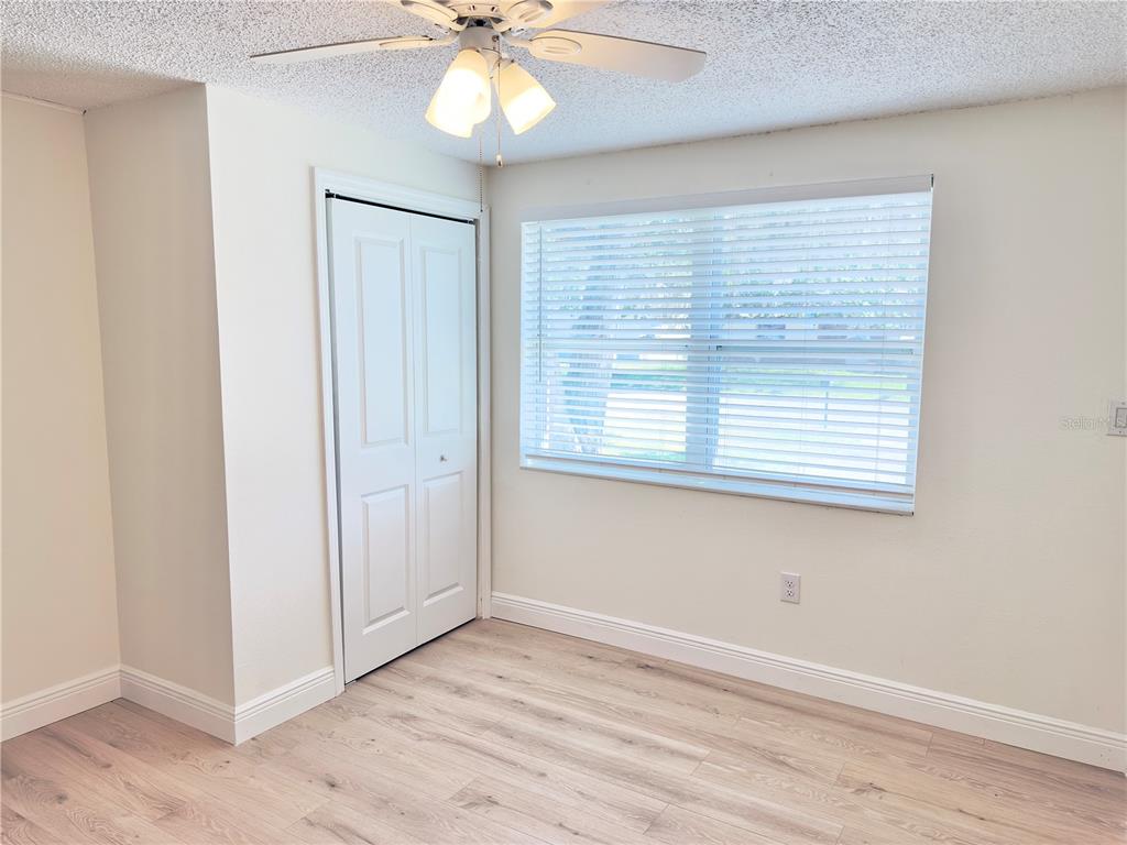 5701 Quist Drive Port Richey, FL 34668 - Photo 18 of 53 a view of an empty room with a window and wooden floor