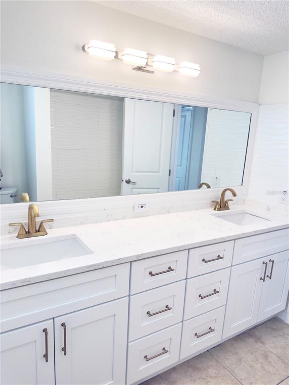 5701 Quist Drive Port Richey, FL 34668 - Photo 21 of 53 a bathroom with a sink double vanity and a mirror