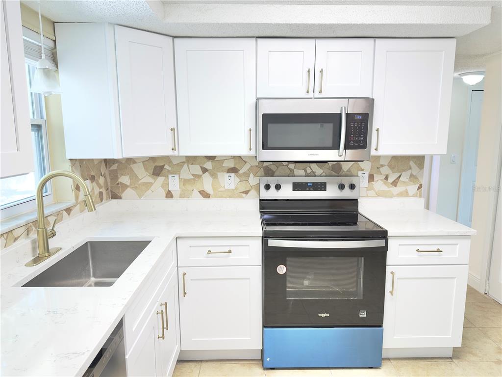 5701 Quist Drive Port Richey, FL 34668 - Photo 26 of 53 a kitchen with a stove and a sink