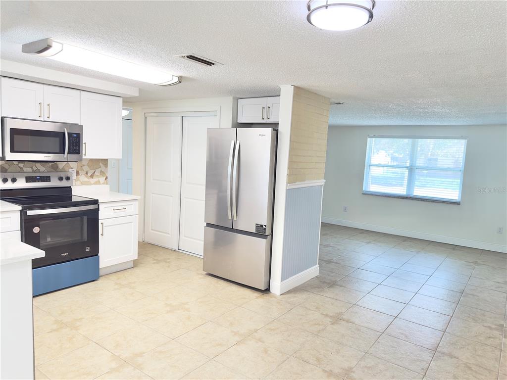 5701 Quist Drive Port Richey, FL 34668 - Photo 28 of 53 a kitchen with stainless steel appliances a refrigerator and a stove top oven