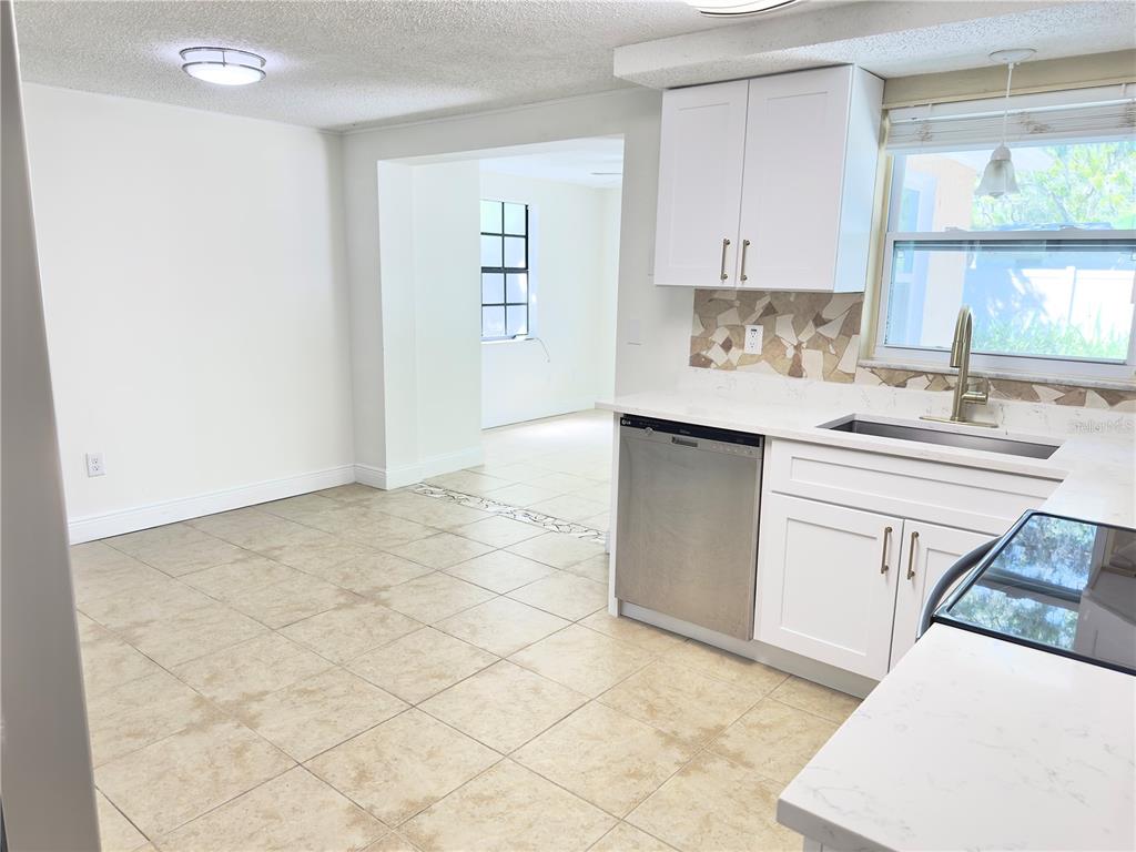 5701 Quist Drive Port Richey, FL 34668 - Photo 29 of 53 a kitchen with stainless steel appliances a sink stove and cabinets