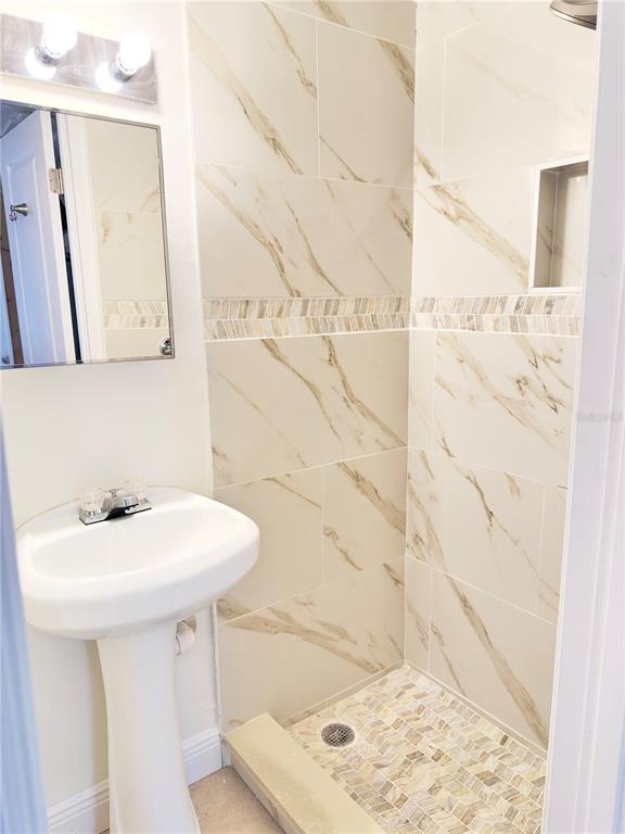 5701 Quist Drive Port Richey, FL 34668 - Photo 40 of 53 a bathroom with a sink a toilet and mirror