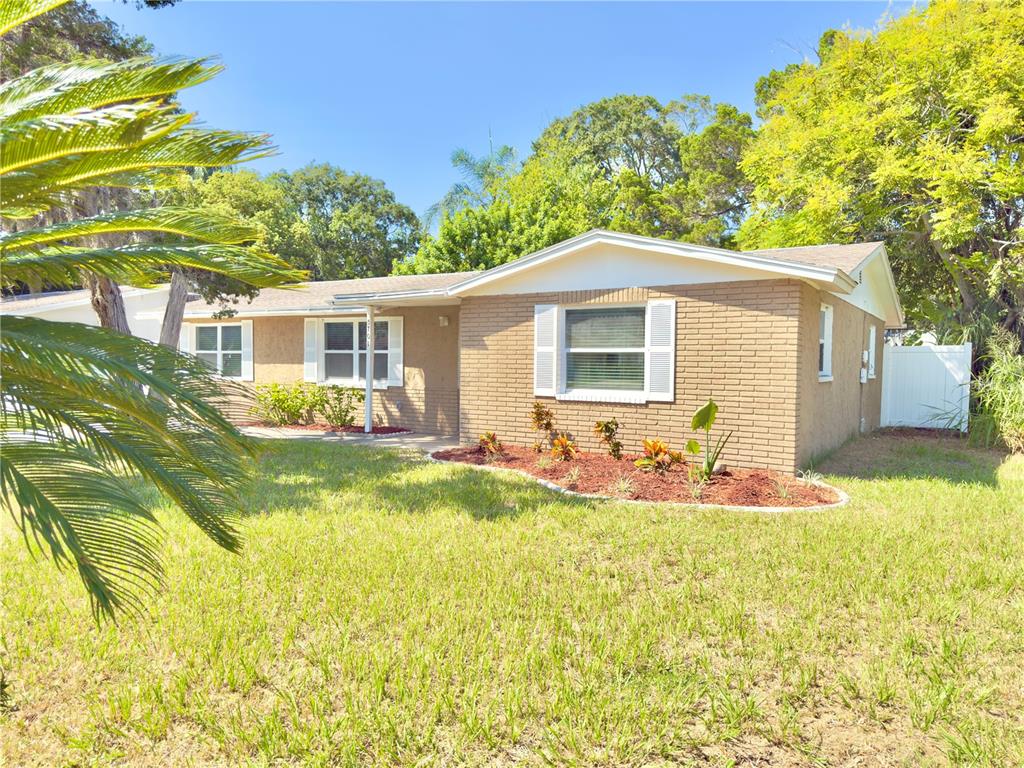 5701 Quist Drive Port Richey, FL 34668 - Photo 4 of 53 a front view of house with yard outdoor seating and barbeque oven